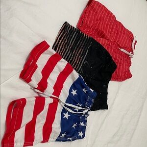 Kids Pair Striped Red and Striped Black Shorts, along with American flag shorts.